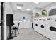 Bright laundry room with coin operated machines, tile floor, and a table with chairs at 2001 S Ocean Blvd. # 905, Myrtle Beach, SC 29577