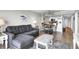 Open-concept living room with a gray sofa, decorative coffee table, and tile flooring leading to a kitchen at 2001 S Ocean Blvd. # 905, Myrtle Beach, SC 29577