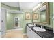 Well-lit bathroom with double sinks, granite countertops, and a decorative mirror at 2151 Bridge View Ct. # 2502, North Myrtle Beach, SC 29582