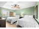 Bright bedroom featuring two beds, ceiling fan, and soothing green walls at 2151 Bridge View Ct. # 2502, North Myrtle Beach, SC 29582