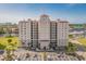 Stunning exterior view of building with red roof, multiple balconies, parking area, and gorgeous waterside views at 2151 Bridge View Ct. # 2502, North Myrtle Beach, SC 29582