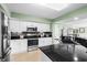 The kitchen features stainless appliances, black countertops, and white cabinets at 2151 Bridge View Ct. # 2502, North Myrtle Beach, SC 29582