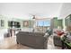 Comfortable living room featuring stylish furniture, a ceiling fan, and access to a balcony with beautiful outdoor views at 2151 Bridge View Ct. # 2502, North Myrtle Beach, SC 29582