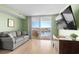 Cozy living room with a comfortable couch, tv, and balcony access overlooking the water at 2151 Bridge View Ct. # 2502, North Myrtle Beach, SC 29582