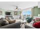 Relaxing living room featuring plush sofas, a ceiling fan, and sliding glass doors leading to a scenic intercostal balcony at 2151 Bridge View Ct. # 2502, North Myrtle Beach, SC 29582