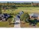 Aerial view of a home with a well-manicured lawn, close to a golf course and green spaces at 565 Bucks Trail, Longs, SC 29568