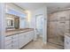 Bright bathroom with dual sink vanity, granite countertops, and glass enclosed tiled shower at 565 Bucks Trail, Longs, SC 29568