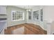 Breakfast nook with bright natural light, wood floors and a charming chandelier at 565 Bucks Trail, Longs, SC 29568