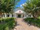 Beautiful community clubhouse with manicured landscaping and a brick pathway leading to the entrance at 565 Bucks Trail, Longs, SC 29568