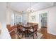 Cozy dining area with a chandelier, and a view of the outside through shuttered windows at 565 Bucks Trail, Longs, SC 29568