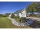Attractive home featuring a brick walkway, manicured lawn, and solar panels on the roof at 565 Bucks Trail, Longs, SC 29568