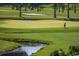 Scenic view of a lush golf course with a small stream and trees in the background at 565 Bucks Trail, Longs, SC 29568