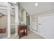 Hallway area leading to a powder room, featuring a vessel sink and access to the staircase at 565 Bucks Trail, Longs, SC 29568