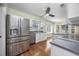 Well-lit kitchen with stainless steel appliances, white cabinets, and hardwood floors at 565 Bucks Trail, Longs, SC 29568
