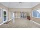 Open living area with tile flooring, and a unique spiral staircase at 565 Bucks Trail, Longs, SC 29568