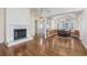 Bright living room featuring hardwood floors, a fireplace, and an open dining area at 565 Bucks Trail, Longs, SC 29568