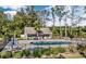 Inviting backyard featuring a private pool, fenced yard, and lounge area surrounded by mature trees at 565 Bucks Trail, Longs, SC 29568