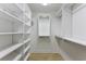 Bright walk-in closet with custom white shelving and storage solutions, providing ample space for organization at 565 Bucks Trail, Longs, SC 29568