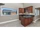 Cherry cabinetry and granite countertops accent this wet bar, featuring an exterior view out the window at 565 Bucks Trail, Longs, SC 29568