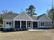 Back view of home featuring a screened in porch and neutral color scheme at 1006 Cuttino St., Georgetown, SC 29440