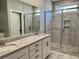 Bathroom featuring a granite vanity, double sinks, and walk-in shower at 1006 Cuttino St., Georgetown, SC 29440