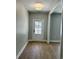 Bright entryway featuring wood floors, white trim, and a view of the front yard at 1006 Cuttino St., Georgetown, SC 29440