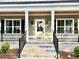 Lovely entryway featuring a bright white door, and black railings to the steps at 1006 Cuttino St., Georgetown, SC 29440