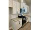 Well-equipped kitchen with white cabinets, granite counters, and stainless steel appliances at 1006 Cuttino St., Georgetown, SC 29440