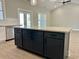Kitchen island with granite countertop and black cabinets with stainless appliances at 1006 Cuttino St., Georgetown, SC 29440