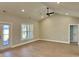 Spacious living room with vaulted ceiling, ceiling fan, and sliding glass door to exterior at 1006 Cuttino St., Georgetown, SC 29440