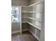 Bright pantry with built-in white shelving and natural light from a window at 1006 Cuttino St., Georgetown, SC 29440