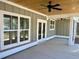 Covered porch featuring a stained ceiling, ceiling fan and view to yard at 1006 Cuttino St., Georgetown, SC 29440