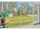 View of spacious backyard with green grass and a storage shed, seen from screened-in porch at 131 Grissett Lake Dr., Conway, SC 29526