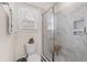 Bathroom with marble-tiled walk-in shower and glass door; toilet with decorative display on top at 131 Grissett Lake Dr., Conway, SC 29526