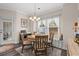 Bright dining area features a round table with seating, a window seat, and a modern chandelier at 131 Grissett Lake Dr., Conway, SC 29526