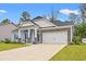 Beautiful home with stone accents, blue siding, and manicured landscaping at 131 Grissett Lake Dr., Conway, SC 29526