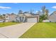Charming home with a stone-accented facade, blue siding, well-manicured lawn, and a long driveway at 131 Grissett Lake Dr., Conway, SC 29526