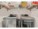 Laundry room showcasing front-load washer and dryer set with shelving and storage solutions at 131 Grissett Lake Dr., Conway, SC 29526