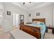Comfortable main bedroom with a decorative wood bed frame, bench, and ensuite bathroom access at 131 Grissett Lake Dr., Conway, SC 29526