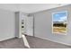 Bright bedroom with gray carpet and light gray walls and a door leading to the outside at 1526 Clubstone Dr., Conway, SC 29526