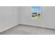 Small bedroom featuring neutral carpet, white walls and a large window at 1526 Clubstone Dr., Conway, SC 29526