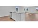 Kitchen island featuring granite countertops and stainless dishwasher, with wood floors at 1526 Clubstone Dr., Conway, SC 29526