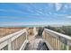 Convenient beach access with a wooden staircase leading to the sand and surf at 2311 S Ocean Blvd. # 438, Myrtle Beach, SC 29577