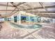Indoor pool with colorful, artistic walls and tables and chairs on the sides at 2311 S Ocean Blvd. # 438, Myrtle Beach, SC 29577
