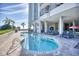Outdoor pool and hot tub area with palm trees and lounge chairs poolside at 2311 S Ocean Blvd. # 438, Myrtle Beach, SC 29577