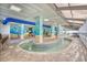 Bright and sunny indoor pool featuring artistic walls with tables and chairs at 2311 S Ocean Blvd. # 438, Myrtle Beach, SC 29577