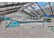 Indoor pool and hot tub area with tables and chairs beneath a transparent roof at 2311 S Ocean Blvd. # 438, Myrtle Beach, SC 29577