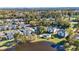 Aerial view of condo community nestled among trees, featuring a lake and pool at 556 White River Dr. # 44F, Myrtle Beach, SC 29579