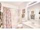 The bathroom features a shower-tub combo, white fixtures, and decorative accents, creating a serene space at 601 Hillside Dr. N # 4133, North Myrtle Beach, SC 29582