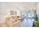 Bright living room boasts comfortable seating, a ceiling fan, and sliding glass doors to outdoor deck at 601 Hillside Dr. N # 4133, North Myrtle Beach, SC 29582